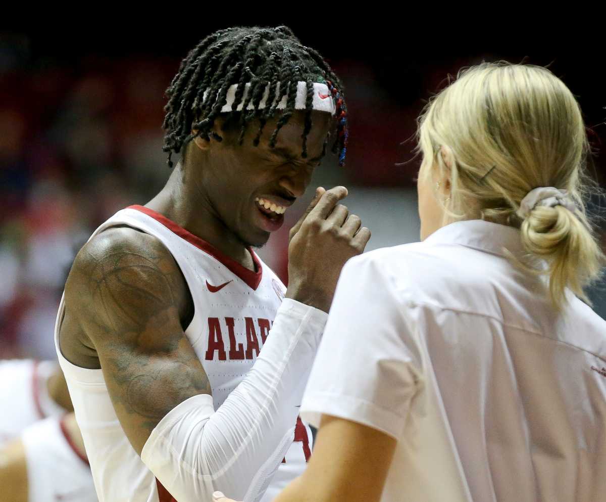 Alabama guard Keon Ellis (14) comes to see a trainer after being hit in the face by and LSU defender in Coleman Coliseum on the campus of the University of Alabama Wednesday, Jan. 19, 2022.
