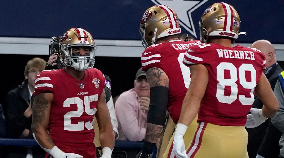 San Francisco 49ers running back Elijah Mitchell (25) Tom Compton, center, and Charlie Woerner (89) celebrate Mitchell's touchdown in the first half of an NFL wild-card playoff football game against the Dallas Cowboys in Arlington, Texas, Sunday, Jan. 16, 2022.