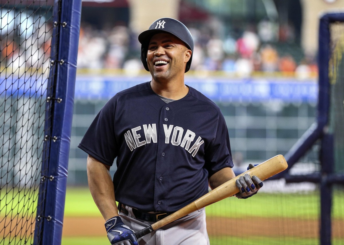 Former Yankees outfielder Carlos Beltran smiles during batting practice