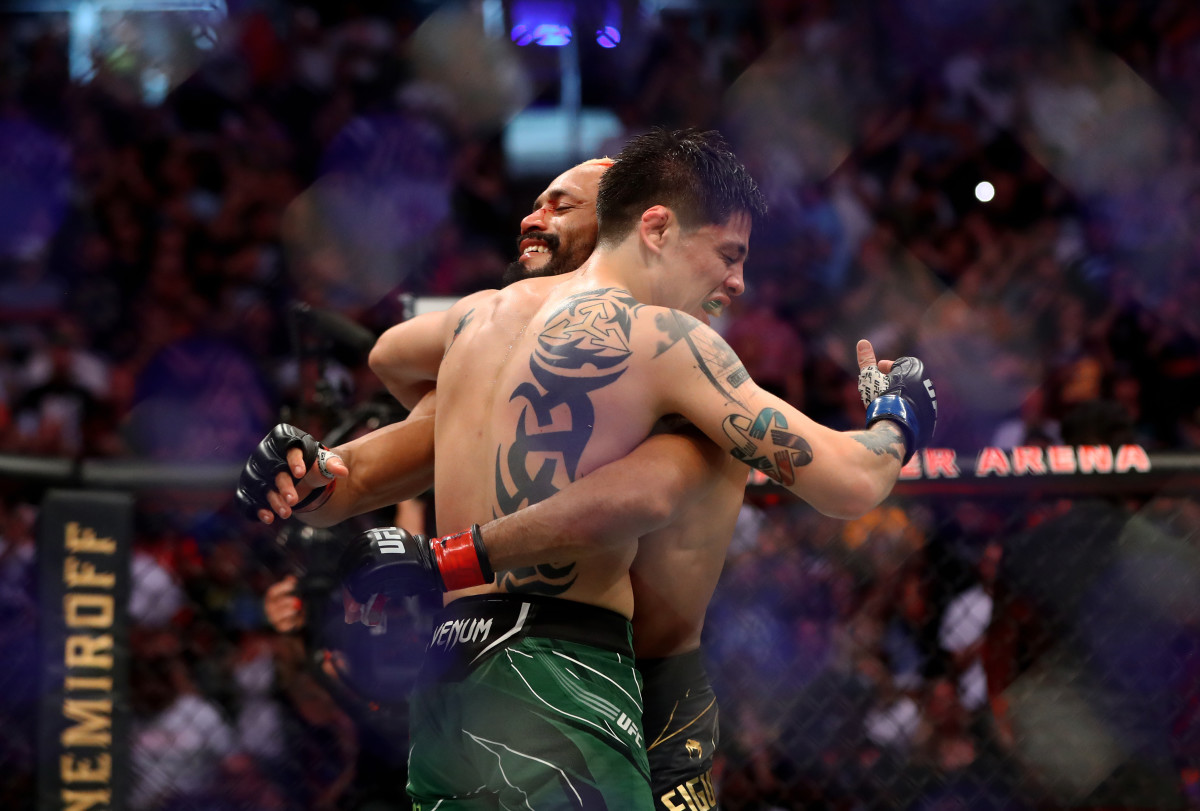 Brandon Moreno (l.) and Deiveson Figueiredo embrace after their fight at UFC 263 on June 12, 2021. 