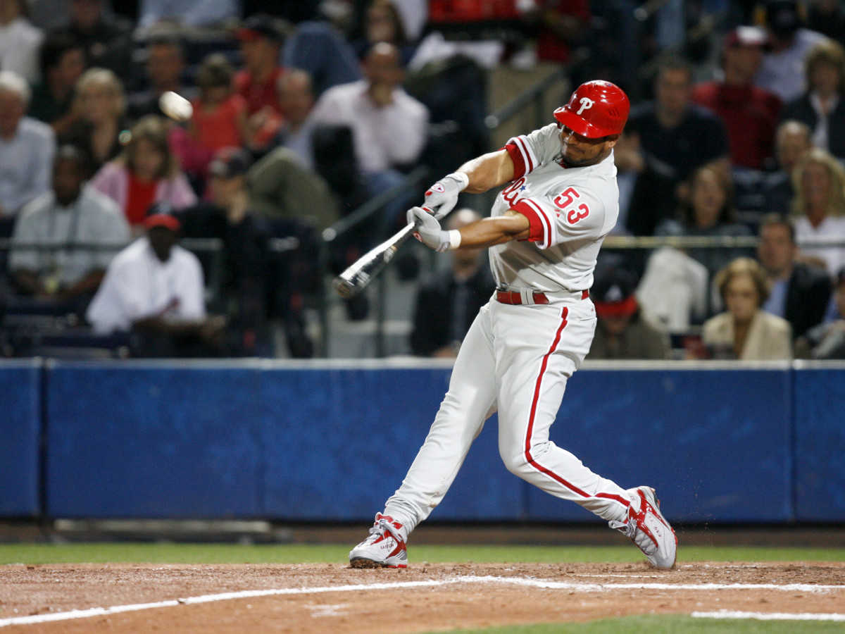 Phillies right fielder Bobby Abreu drives in 
shortstop Jimmy Rollins against the Braves at Turner Field in Atlanta.