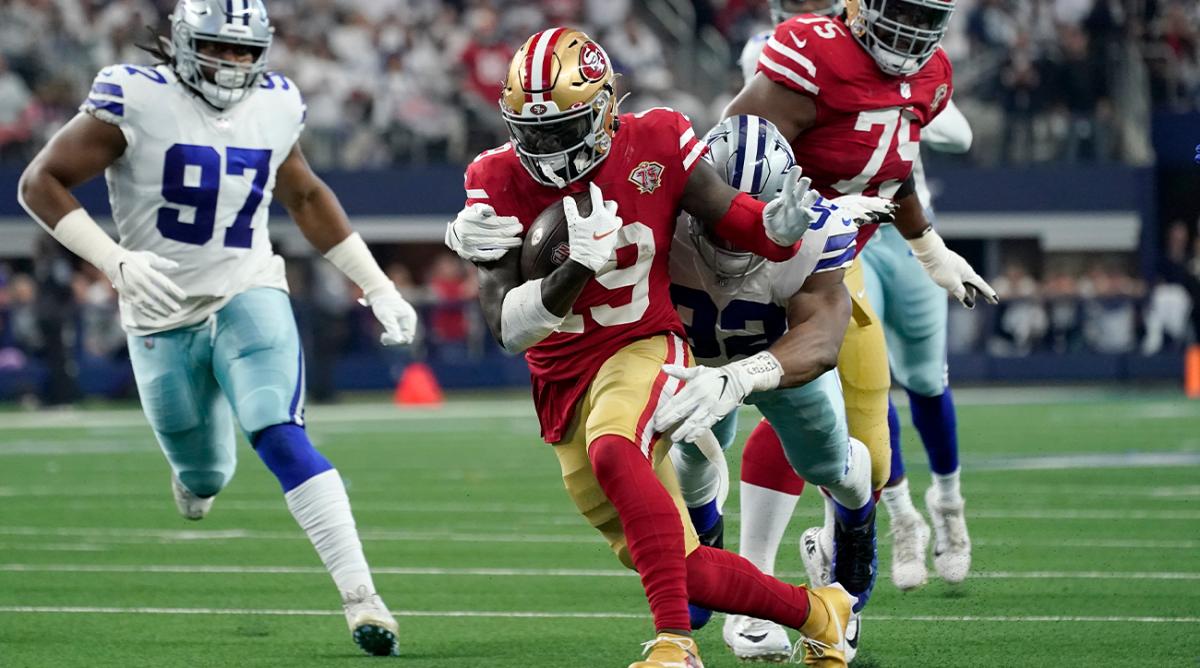 San Francisco 49ers wide receiver Deebo Samuel (19) attempts to escape the grasp of Dallas Cowboys defensive end Dorance Armstrong (92) as defensive tackle Osa Odighizuwa (97) moves in to help make the tackle in the first half of an NFL wild-card playoff football game in Arlington, Texas, Sunday, Jan. 16, 2022.