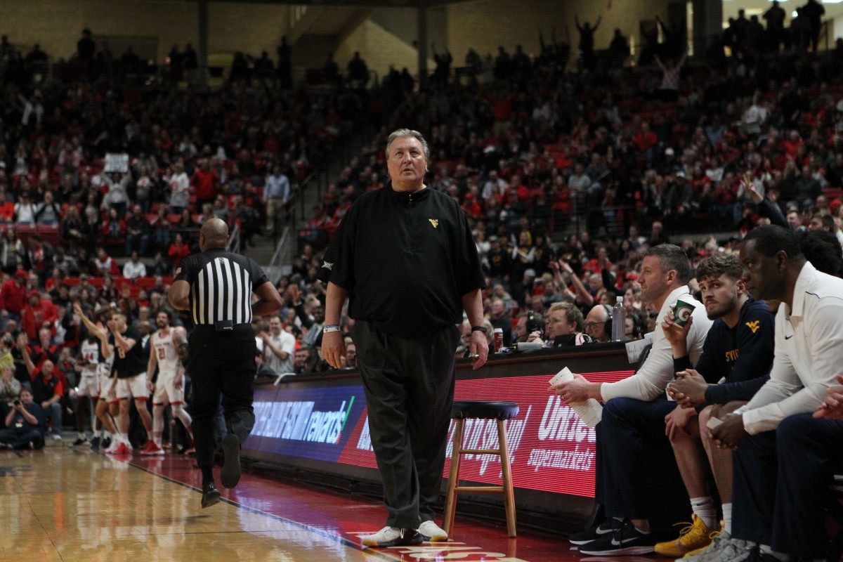 Jan 29, 2020; Lubbock, Texas, USA; West Virginia Mountaineers head coach Bob Huggins checks the scoreboard in the first half during the game against the Texas Tech Red Raiders at United Supermarkets Arena.