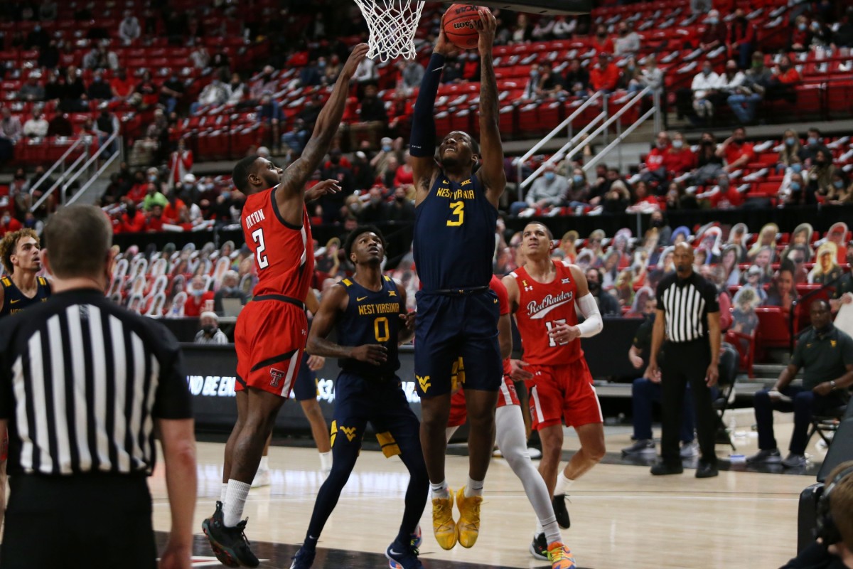 Feb 9, 2021; Lubbock, Texas, USA; West Virginia Mountaineers forward Gabe Osabuohien (3) goes to the basket against Texas Tech Red Raiders guard Jamarius Burton (2) in the second half at United Supermarkets Arena.
