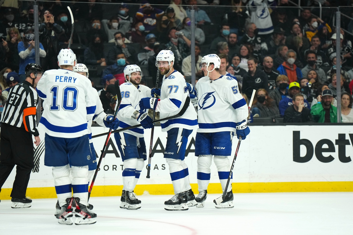 Jan 18, 2022; Los Angeles, California, USA; Tampa Bay Lightning defenseman Victor Hedman (77) celebrates with right wing Corey Perry (10) and right wing Nikita Kucherov (86) and defenseman Cal Foote (52) after scoring a goal against the LA Kings in the third period at Crypto.com Arena. Mandatory Credit: Kirby Lee-USA TODAY Sports