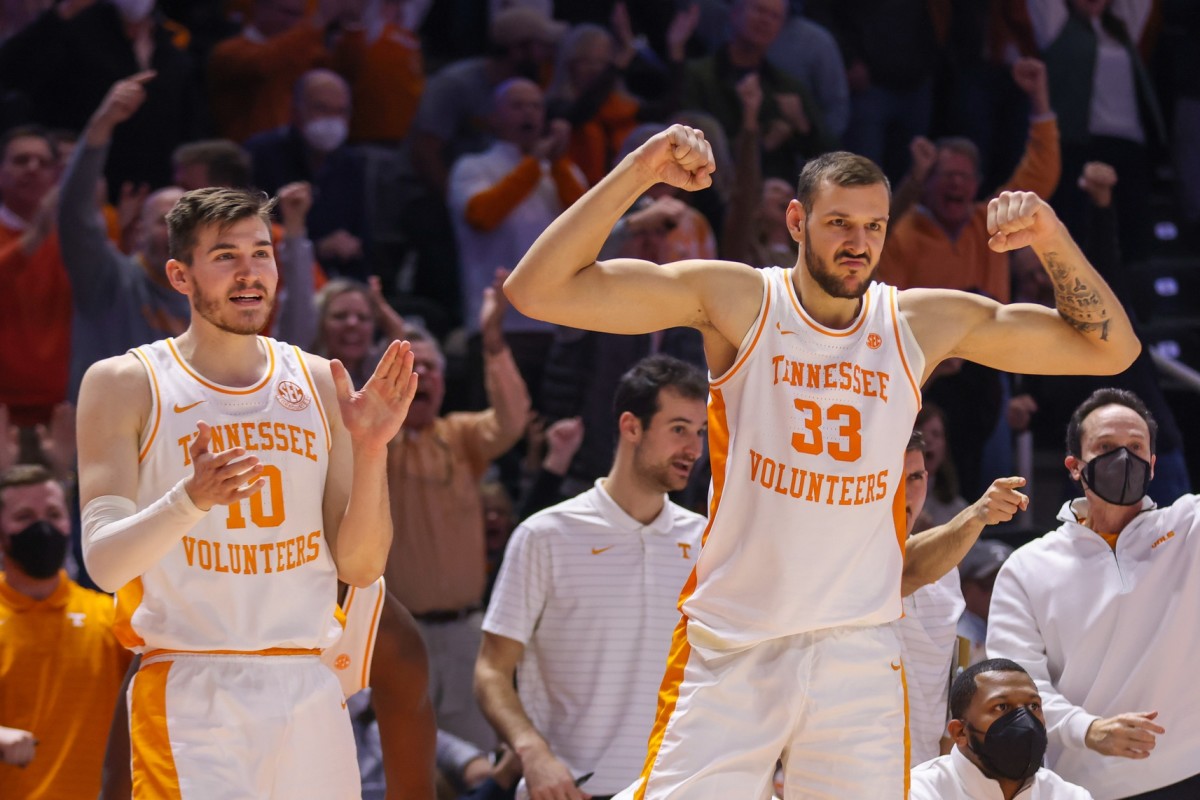 Tennessee Volunteers forward John Fulkerson (10) and forward Uros Plavsic (33) react from the bench during overtime against the Mississippi Rebels at Thompson-Boling Arena.