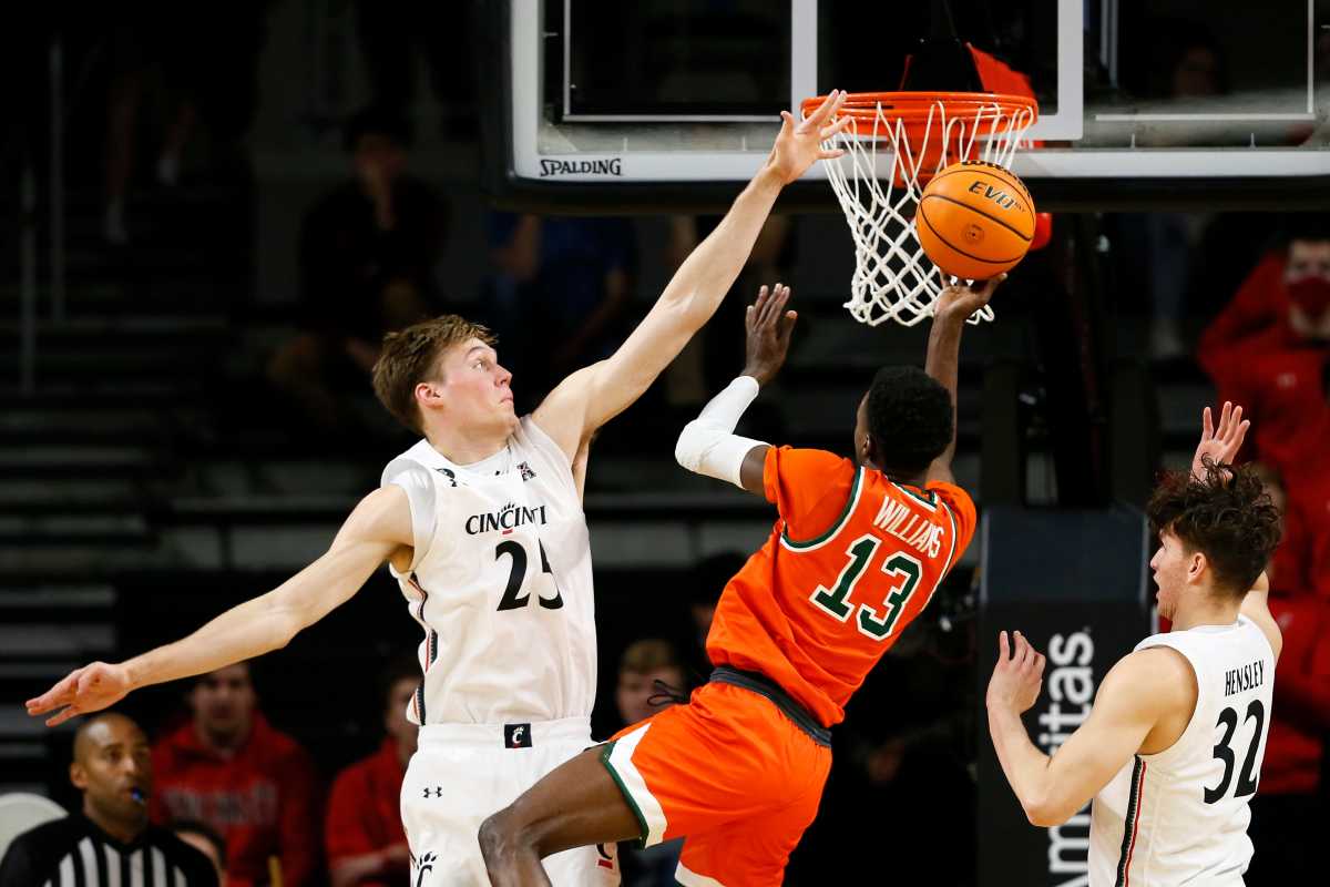 Cincinnati Bearcats center Hayden Koval (25) blocks a shot by Florida A&M Rattlers guard Jamir Williams (13) in the second half of the NCAA basketball game between the Cincinnati Bearcats and the Florida A&M Rattlers at Fifth Third Arena in Cincinnati on Tuesday, Dec. 14, 2021. The Bearcats extended a halftime lead to finish 77-50 over FAMU. Florida A M Rattlers At Cincinnati Bearcats Basketball