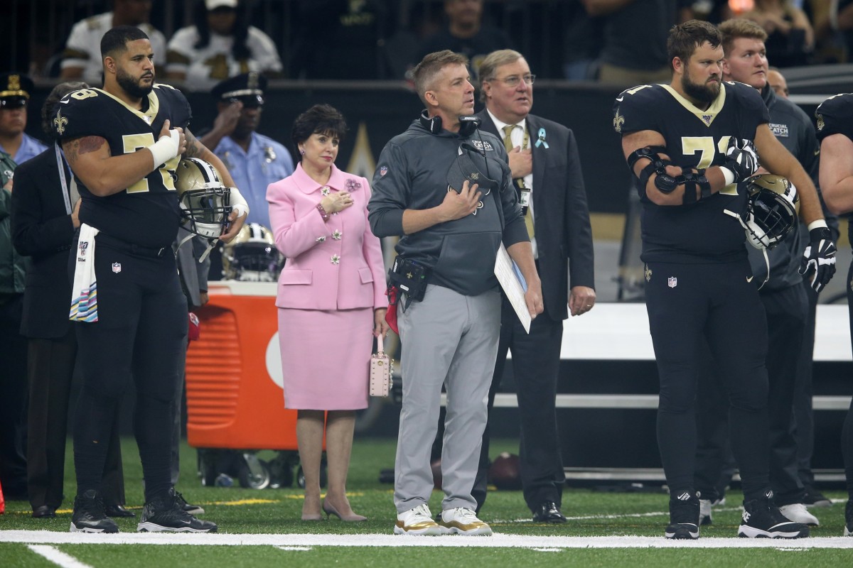 New Orleans Saints head coach Sean Payton stands during the National Anthem with team owner Gayle Benson