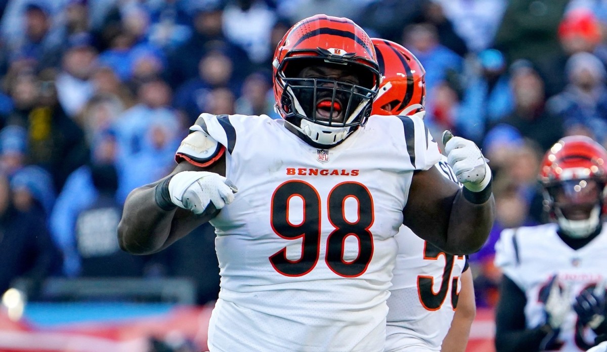 Cincinnati Bengals nose tackle D.J. Reader (98) celebrates a tackle of Tennessee Titans running back Derrick Henry (22), background, in the first quarter during an NFL divisional playoff football game, Saturday, Jan. 22, 2022, at Nissan Stadium in Nashville. Cincinnati Bengals At Tennessee Titans Jan 22 Afc Divisional Playoffs