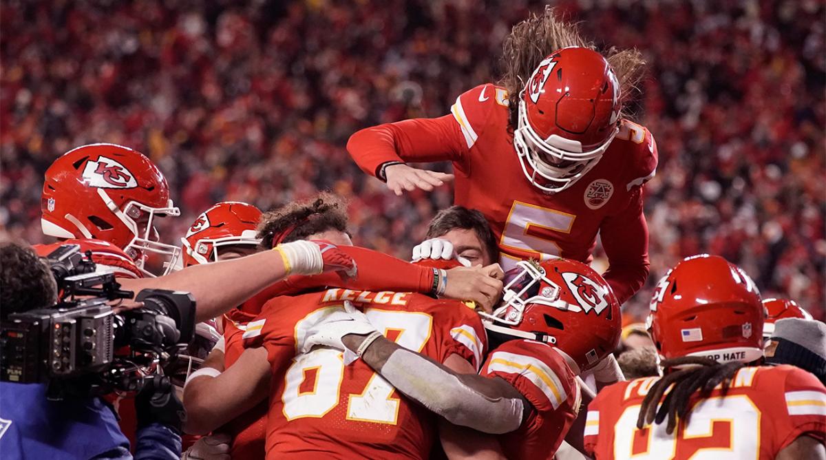 Kansas City Chiefs tight end Travis Kelce (87) celebrates with teammates after catching an 8-yard touchdown pass during overtime in an NFL divisional round playoff football game against the Buffalo Bills, Sunday, Jan. 23, 2022, in Kansas City, Mo. The Chiefs won 42-36.