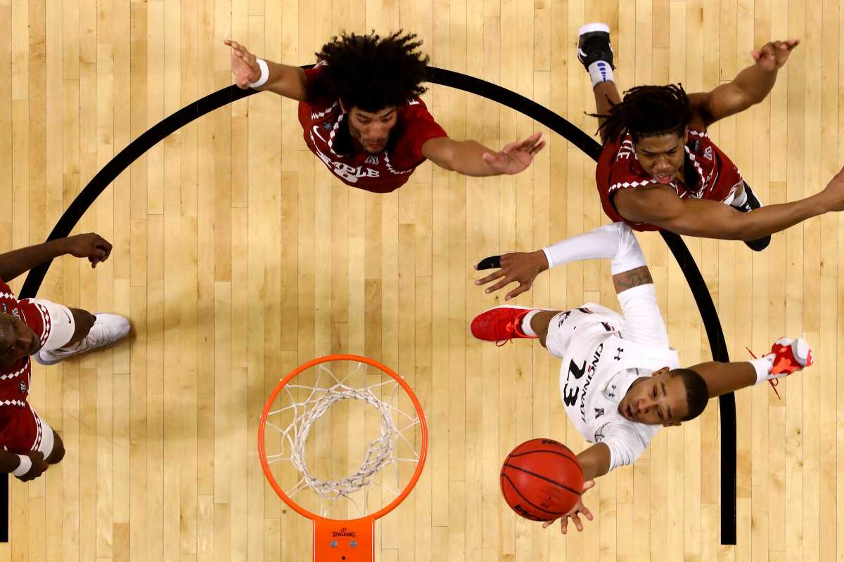 Cincinnati Bearcats guard Mika Adams-Woods (23) scores at the basket in the second half of an NCAA men's college basketball game against the Temple Owls, Friday, Feb. 12, 2021, at Fifth Third Arena in Cincinnati. The Cincinnati Bearcats won, 71-69. Temple Owls At Cincinnati Bearcats Feb 12