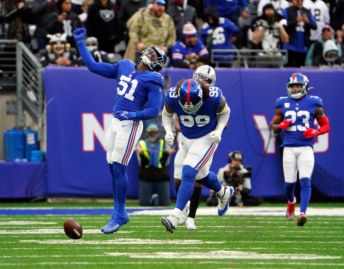 New York Giants linebacker Azeez Ojulari (51) and defensive end Leonard Williams (99) react after Williams bats down the ball thrown by Las Vegas Raiders quarterback Derek Carr (not pictured) in the second half at MetLife Stadium. The Giants defeat the Raiders, 23-16, on Sunday, Nov. 7, 2021, in East Rutherford.