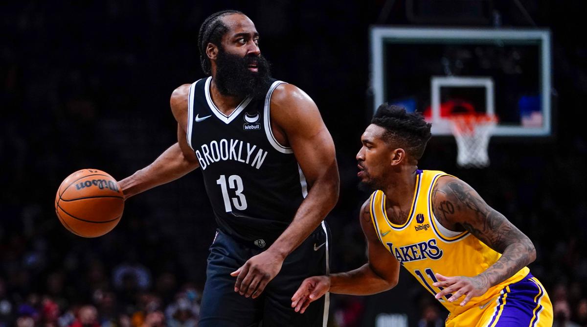 Los Angeles Lakers' Malik Monk (11) defends Brooklyn Nets' James Harden (13) during the second half of an NBA basketball game Tuesday, Jan. 25, 2022 in New York. The Lakers won 106-96. (AP Photo/Frank Franklin II)