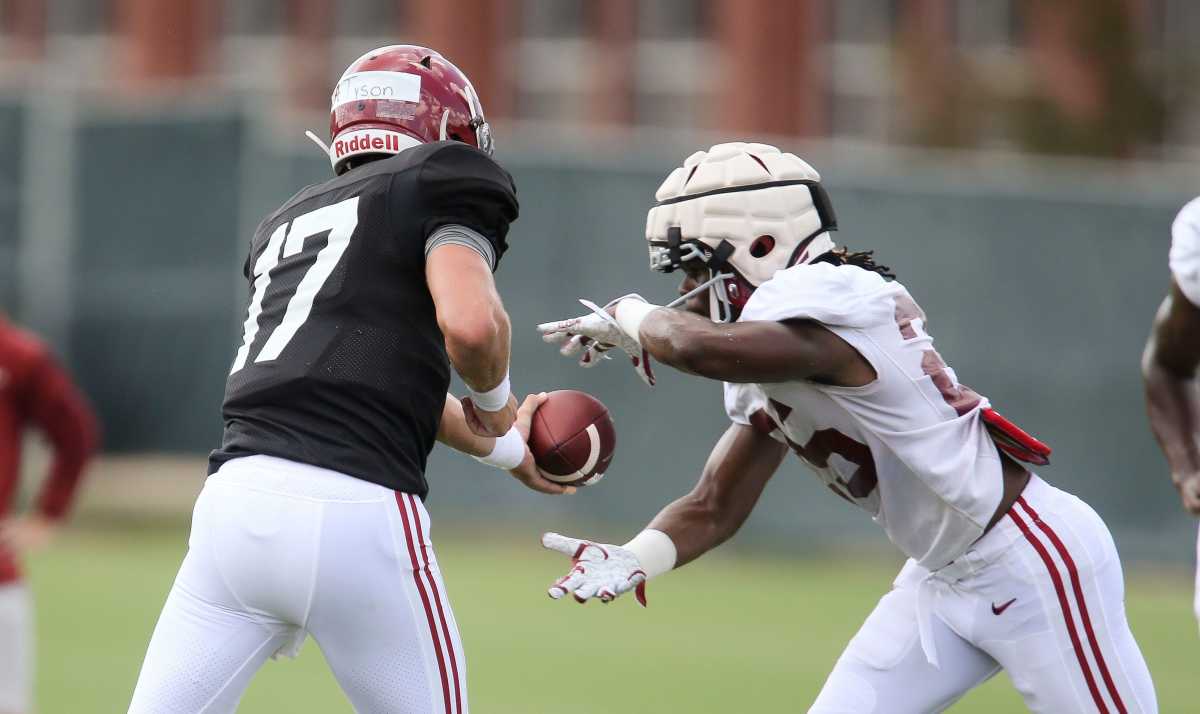 Quarterback Paul Tyson (17) hands off to running back Camar Wheaton (25) during practice for the Crimson Tide Thursday, Aug. 12, 2021.