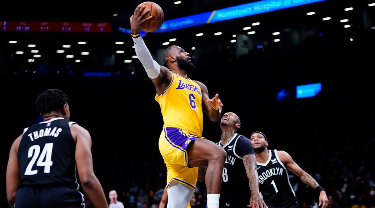 Los Angeles Lakers' LeBron James (6) drives past Brooklyn Nets' James Johnson (16) as Cam Thomas (24) watches during the first half.
