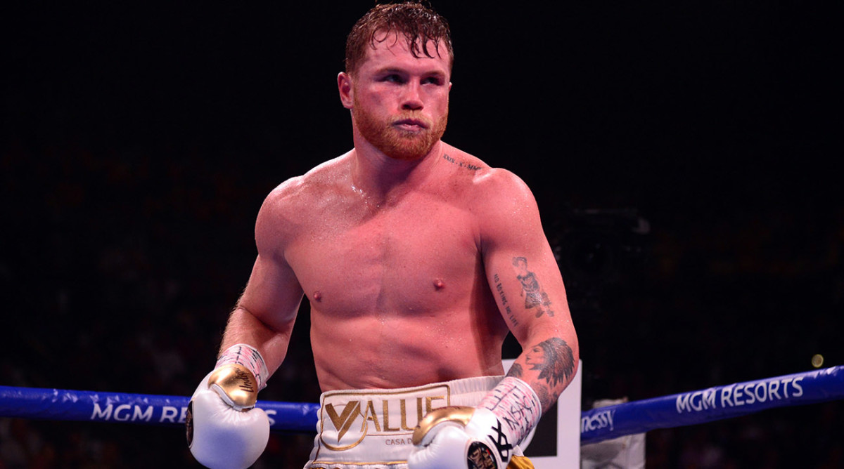 Canelo Alvarez (gold/white trunks) and Caleb Plant (white/gray trunks) box during their undisputed super middleweight world championship.