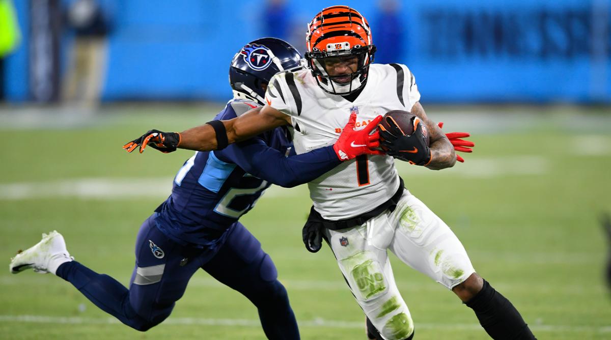 Tennessee Titans cornerback Janoris Jenkins (20) tackles Cincinnati Bengals wide receiver Ja'Marr Chase (1) during the second half of an NFL divisional round playoff football game, Saturday, Jan. 22, 2022, in Nashville, Tenn.