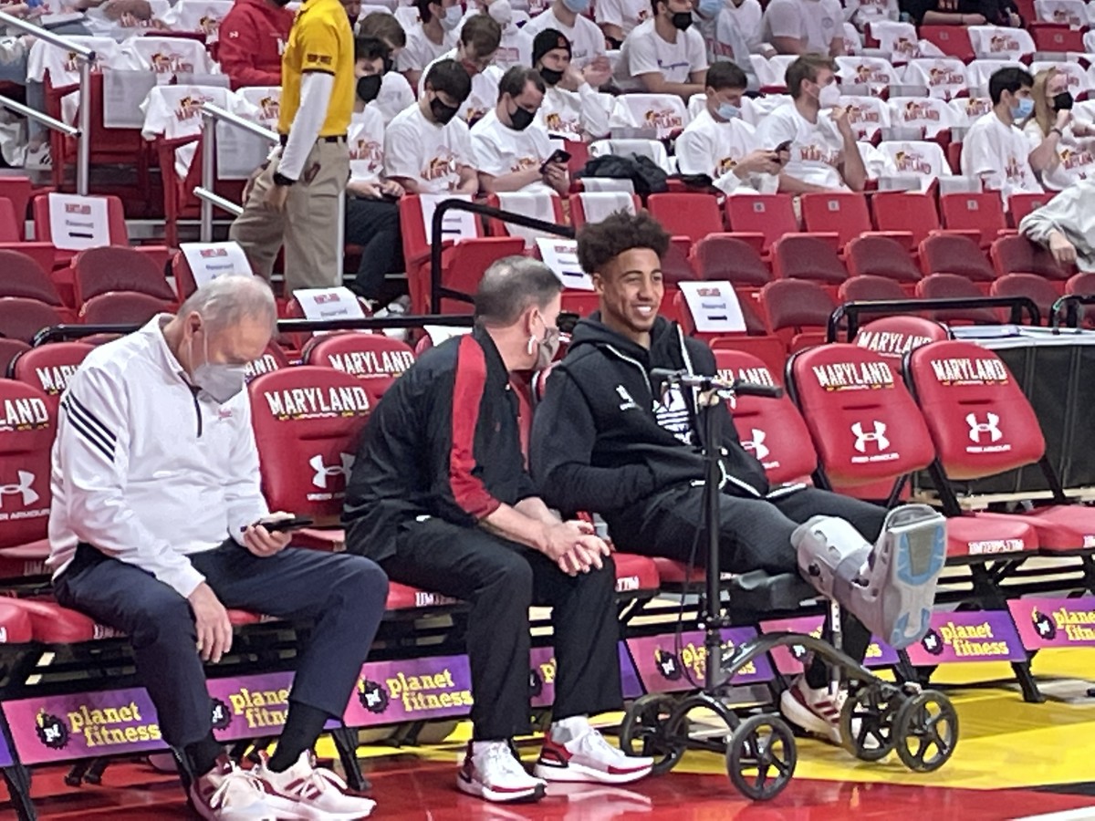 Indiana guard Rob Phinisee smiles on the bench with his scooter and boot prior to Saturday’s game at Maryland. 
