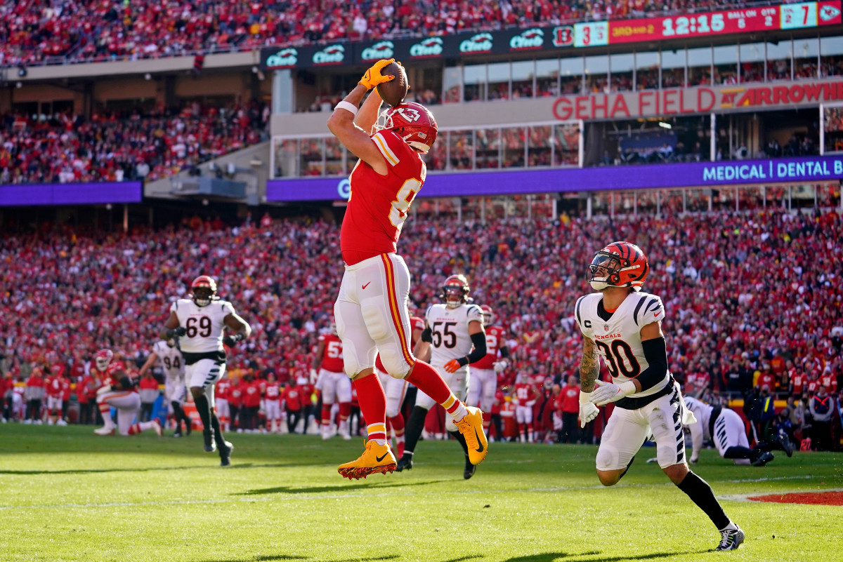 Jan 30, 2022; Kansas City, Missouri, USA; Kansas City Chiefs tight end Travis Kelce (87) catches a pass for a touchdown as Cincinnati Bengals free safety Jessie Bates (30) looks on during the first quarter of the AFC Championship Game at GEHA Field at Arrowhead Stadium. Mandatory Credit: Jay Biggerstaff-USA TODAY Sports