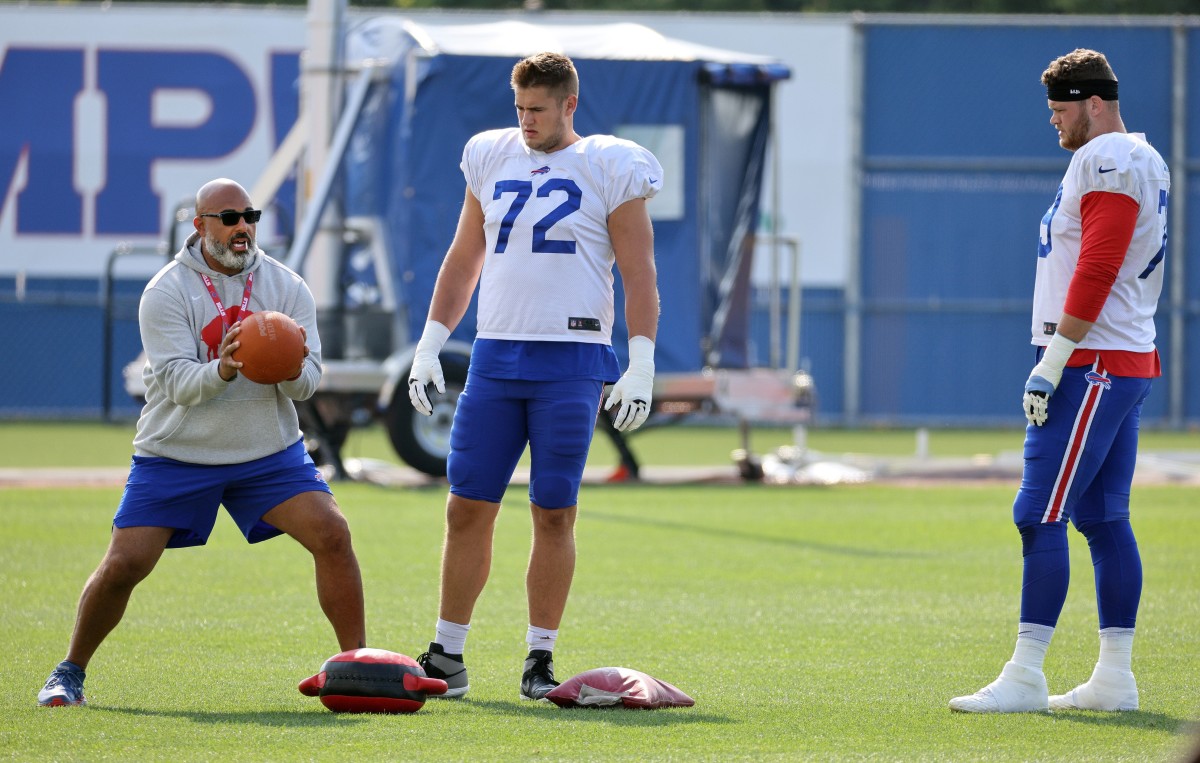 Bills offensive line coach Bobby Johnson works with Tommy Doyle (72) and Spencer Brown.
