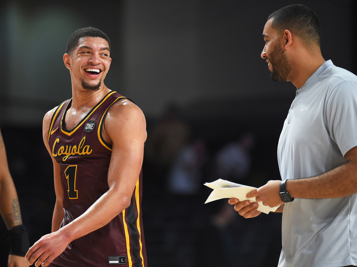 Loyola Chicago's Lucas Williamson laughs with coach Drew Valentine