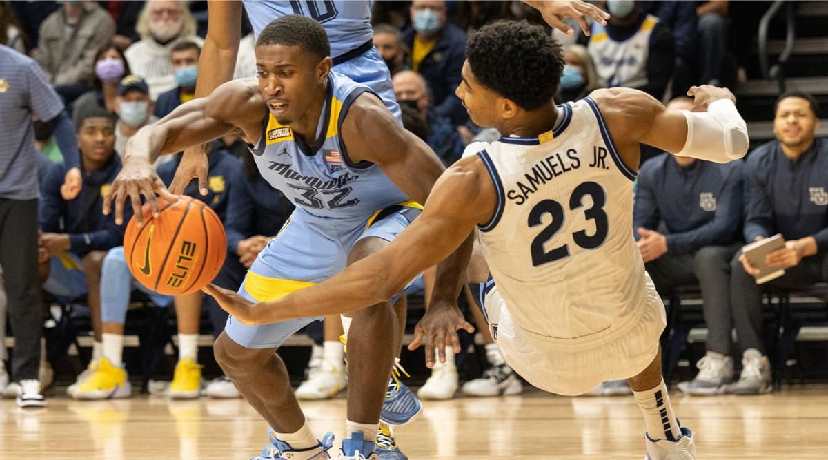 Marquette guard Darryl Morsell (32) and Villanova forward Jermaine Samuels (23) reach for a rebound during the first half of an NCAA college basketball game, Wednesday, Jan. 19, 2022, in Villanova, Pa.