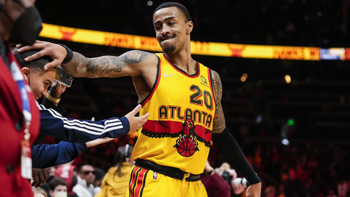 Atlanta Hawks forward John Collins (20) reacts with Trae Young s brother Tim after the Hawks defeated the Los Angeles Lakers.