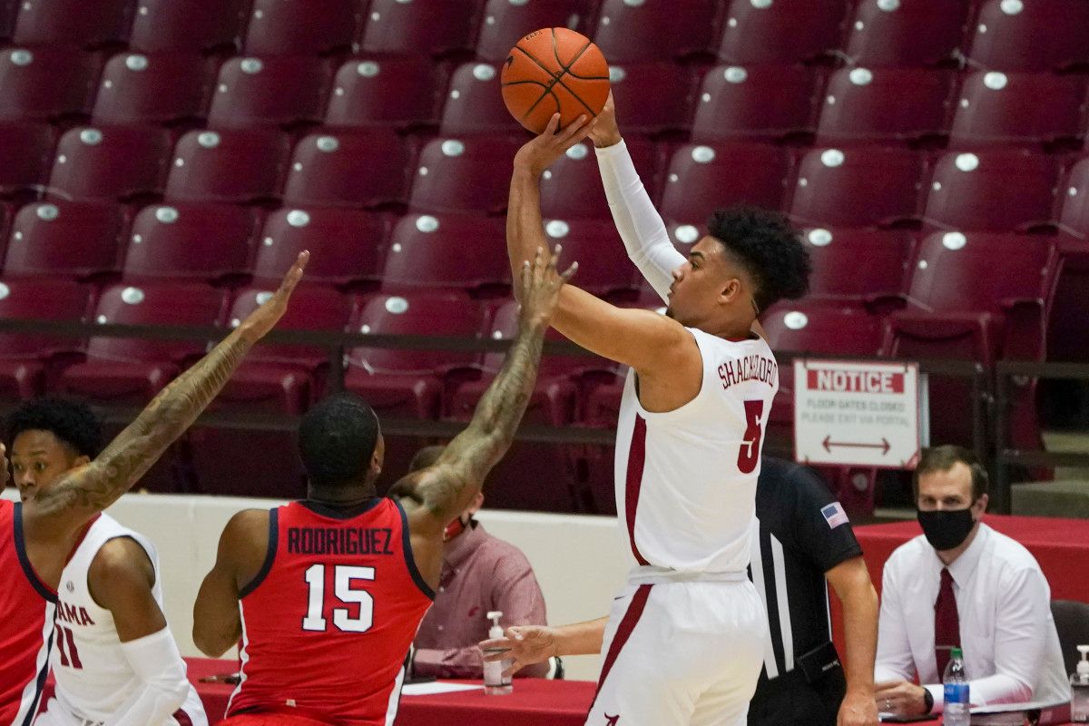 Alabama Crimson Tide guard Jaden Shackelford (5) shoots against Mississippi Rebels guard Luis Rodriguez (15) at Coleman Coliseum.