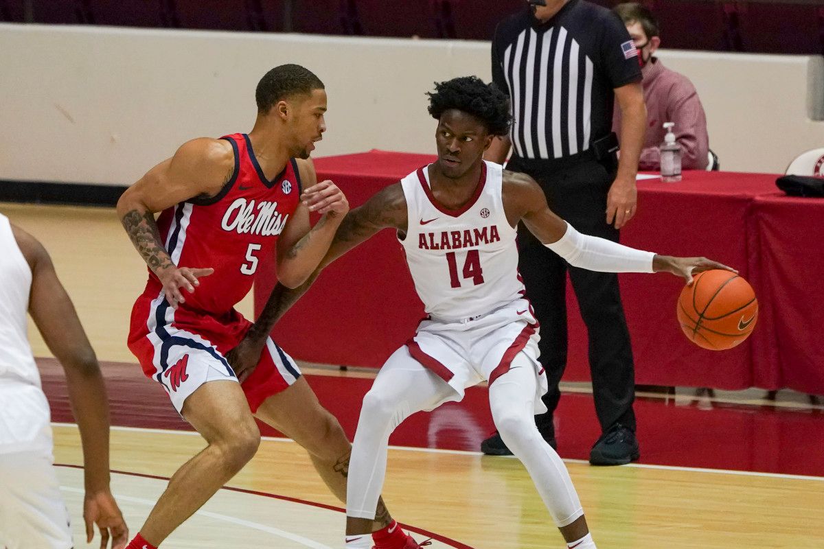 Alabama Crimson Tide guard Keon Ellis (14) controls the ball against Mississippi Rebels forward KJ Buffen (5) during the first half at Coleman Coliseum.