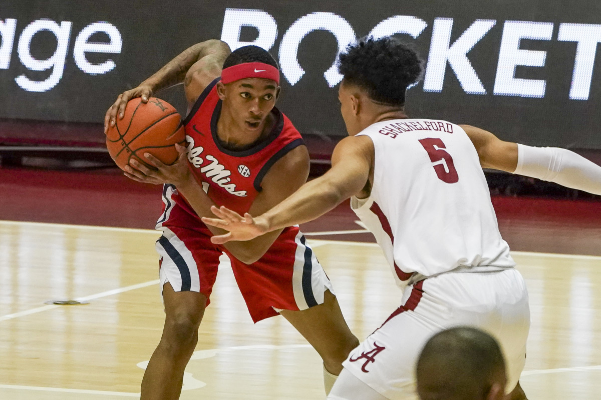 Mississippi Rebels guard Austin Crowley (1) controls the ball against Alabama Crimson Tide guard Jaden Shackelford (5) during the first half at Coleman Coliseum.