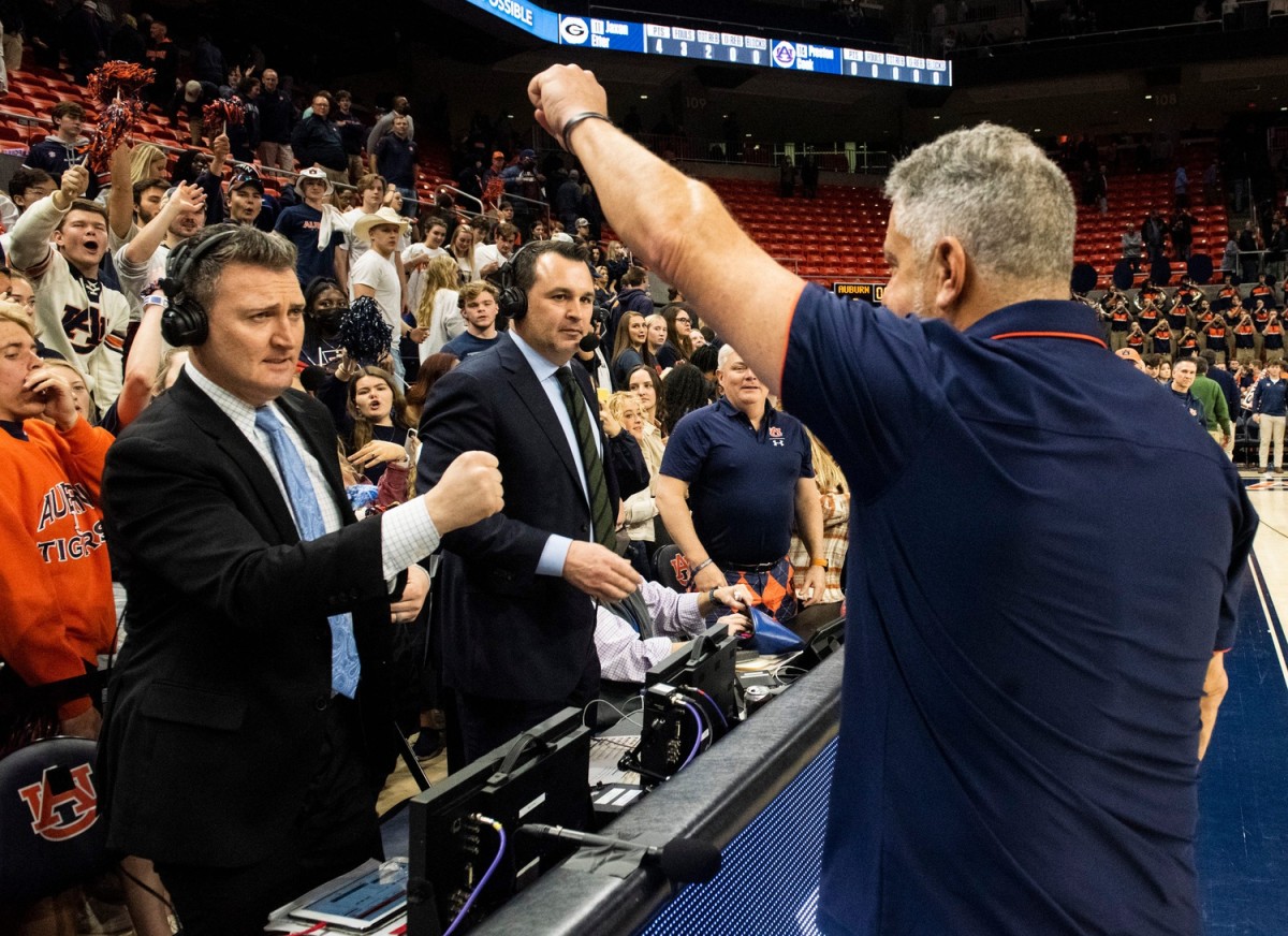 Auburn Tigers head coach Bruce Pearl acknowledges the crowd after the game in front of ESPN broadcasters Pat Bradley (left) and Tom Hart (green tie) as Auburn Tigers take on Georgia Bulldogs at Auburn Arena on Wednesday, Jan. 19. Auburn Tigers defeated Georgia Bulldogs 83-60.