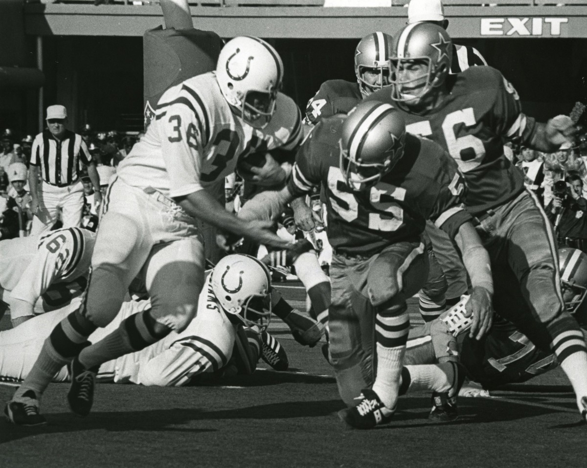 Baltimore Colts running back Norm Buliach (36) carries the ball as Dallas Cowboys linebackers Lee Roy Jordan (55) and Tom Stincic (56) defend in Super Bowl V at the Orange Bowl.