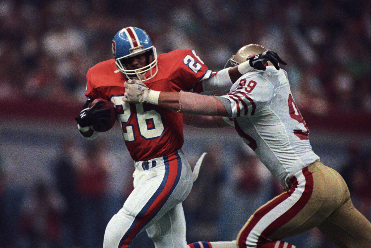 Denver Broncos running back Bobby Humphrey (26) carries the ball against San Francisco 49ers linebacker Michael Walter (99) during Super Bowl XXIV at the Superdome.