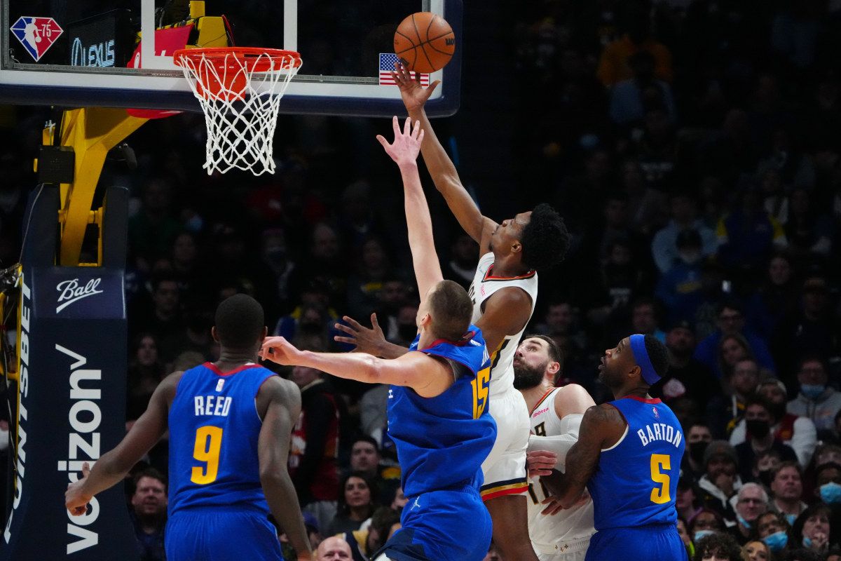 New Orleans Pelicans forward Herbert Jones (5) shoots past guard Davon Reed (9) and center Nikola Jokic (15) and forward Will Barton (5) in the second half at Ball Arena.