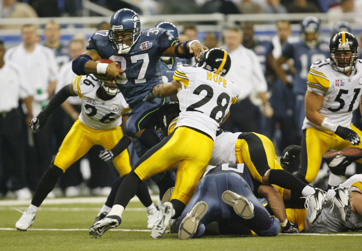 Seattle Seahawks running back Shaun Alexander tries to break through the Pittsburgh Steelers defense in the fourth quarter of Super Bowl XL at Ford Field. Steelers cornerback Deshea Townsend (26) is the background.