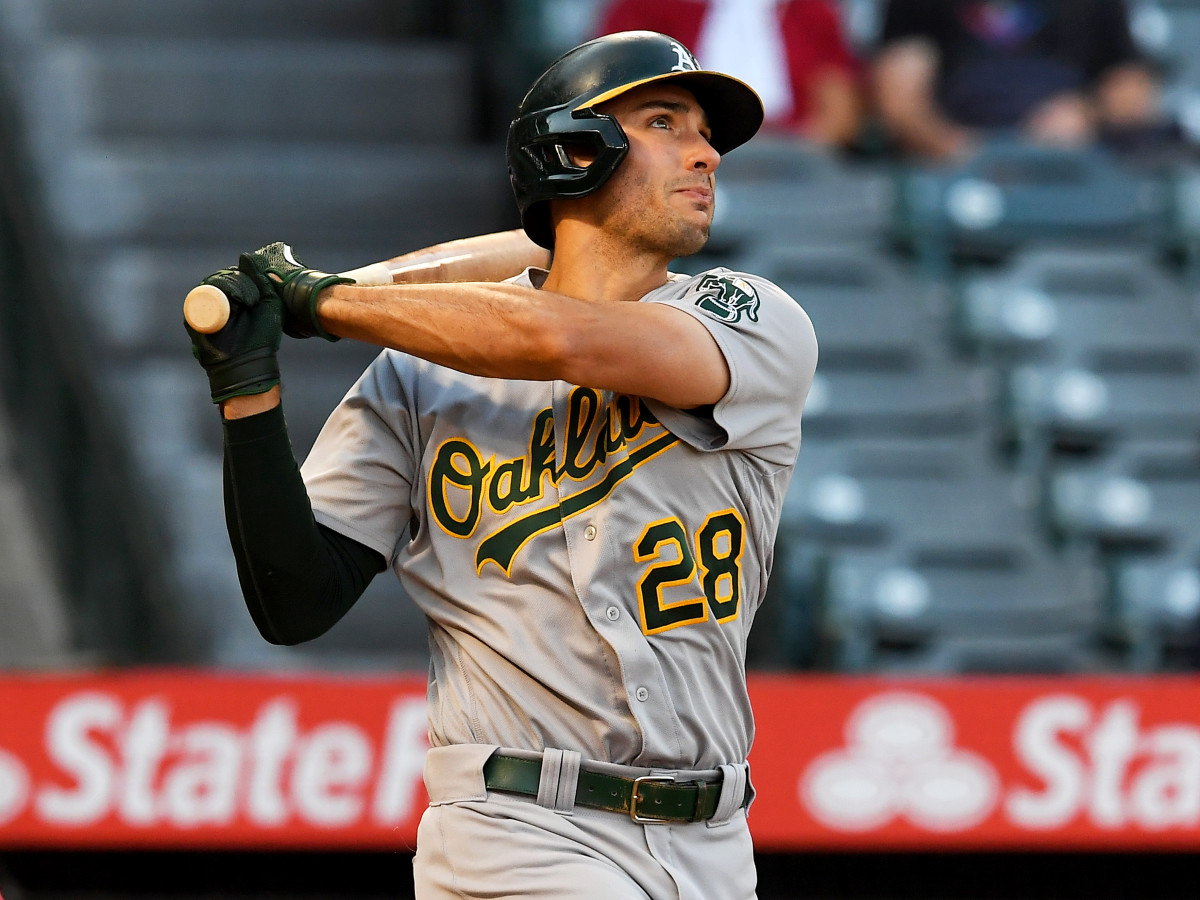 Sep 18, 2021; Anaheim, California, USA;  Oakland Athletics first baseman Matt Olson (28) hits a solo home run against the Los Angeles Angels in the first inning at Angel Stadium.