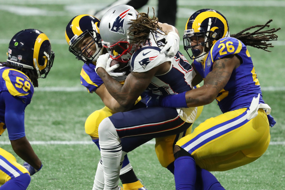 New England Patriots wide receiver Cordarrelle Patterson (84) is tackled by Los Angeles Rams nose tackle Ndamukong Suh (93) and inside linebacker Mark Barron (26) during the second quarter of Super Bowl LIII at Mercedes-Benz Stadium.