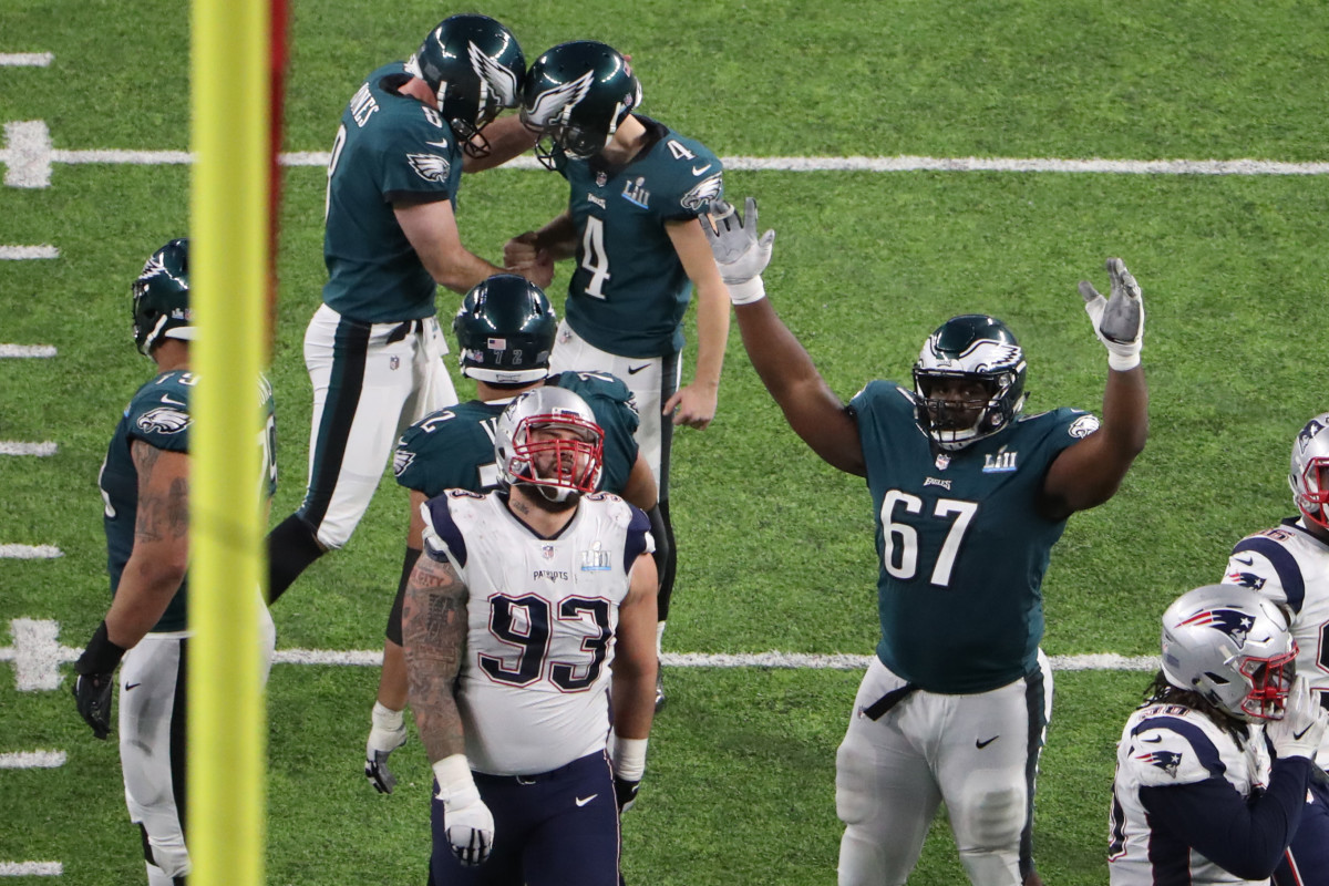 New England Patriots defensive end Lawrence Guy (93) reacts as Philadelphia Eagles offensive guard Chance Warmack (67) celebrates after an Eagles field goal by kicker Jake Elliott (4) during the fourth quarter in Super Bowl LII at U.S. Bank Stadium.