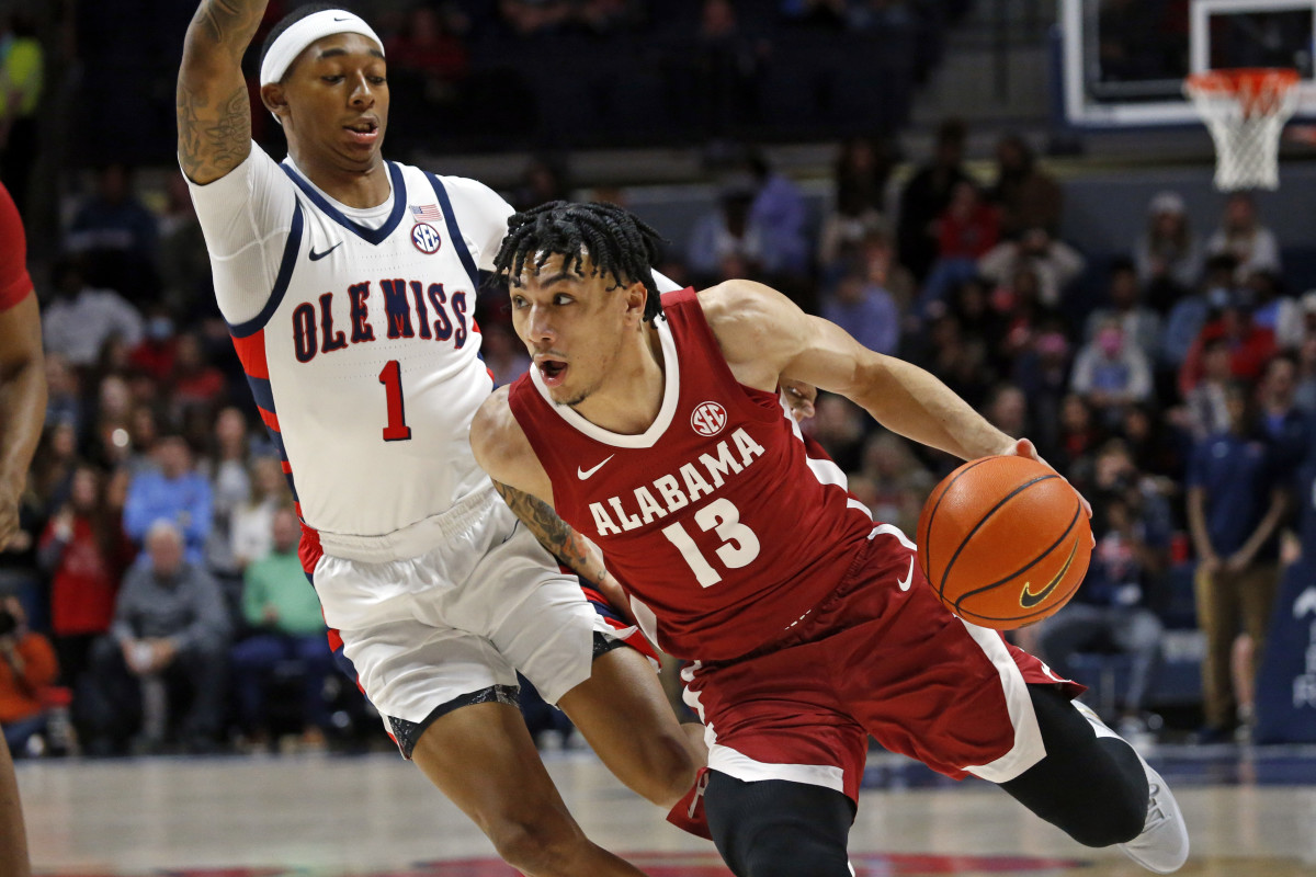 Alabama Crimson Tide guard Jahvon Quinerly (13) drives to the basket as Mississippi Rebels guard Austin Crowley (1) defends during the first half at The Sandy and John Black Pavilion at Ole Miss.
