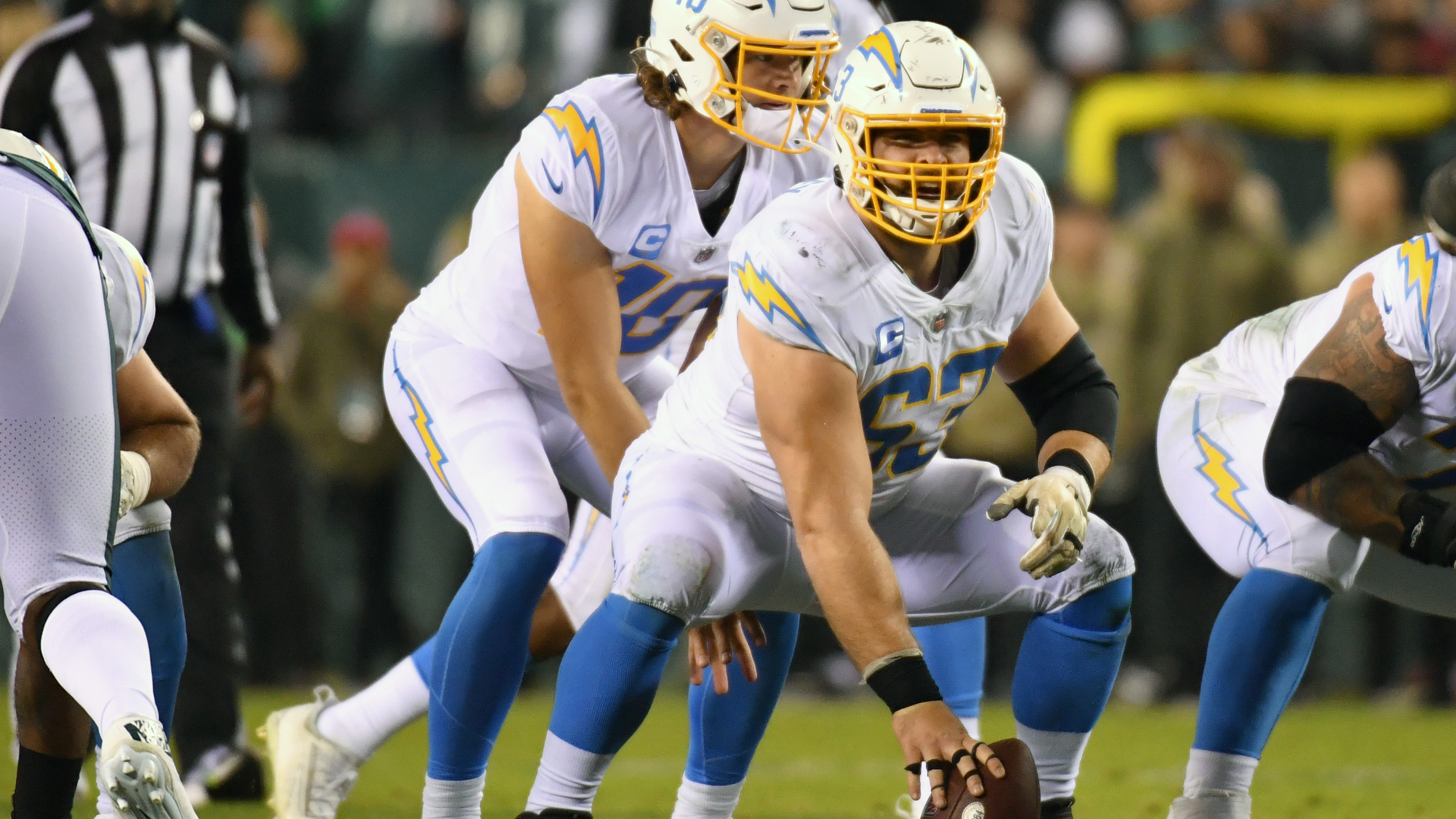 Los Angeles Chargers offensive lineman Corey Linsley delivers a snap to Justin Herbert