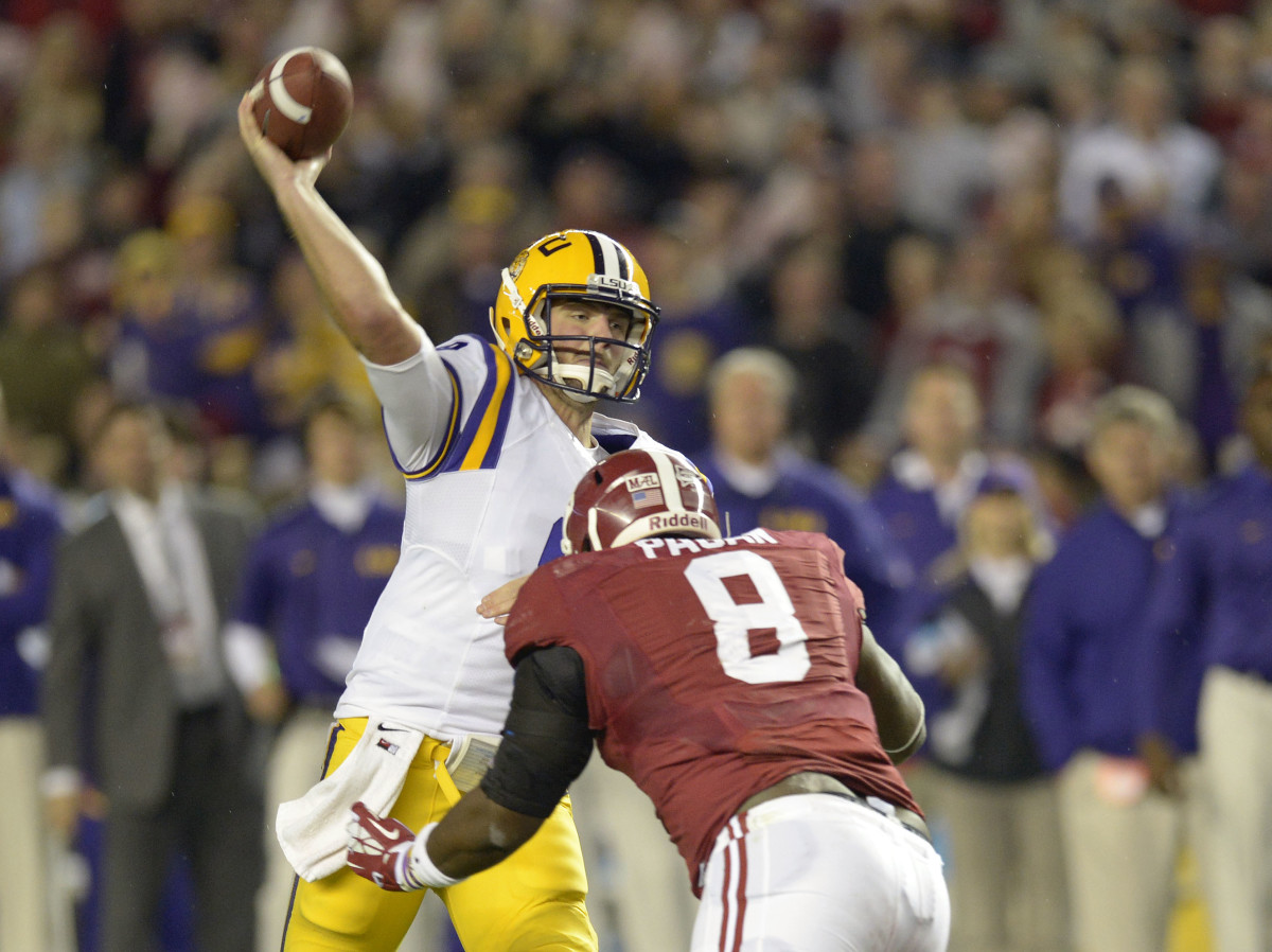LSU Tigers quarterback Zach Mettenberger (8) throws the ball as he is pressured by Alabama Crimson Tide defensive lineman Jeoffrey Pagan (8) in the second quarter at Bryant-Denny Stadium.