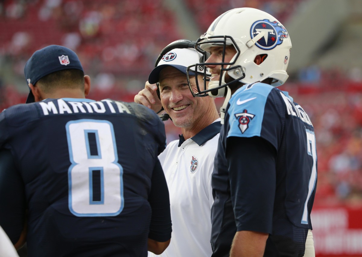 Tennessee Titans head coach Ken Whisenhunt smiles as he talks with quarterback Marcus Mariota (8) and quarterback Zach Mettenberger (7) during the second half against the Tampa Bay Buccaneers at Raymond James Stadium. Tennessee Titans defeated the Tampa Bay Buccaneers 42-14.