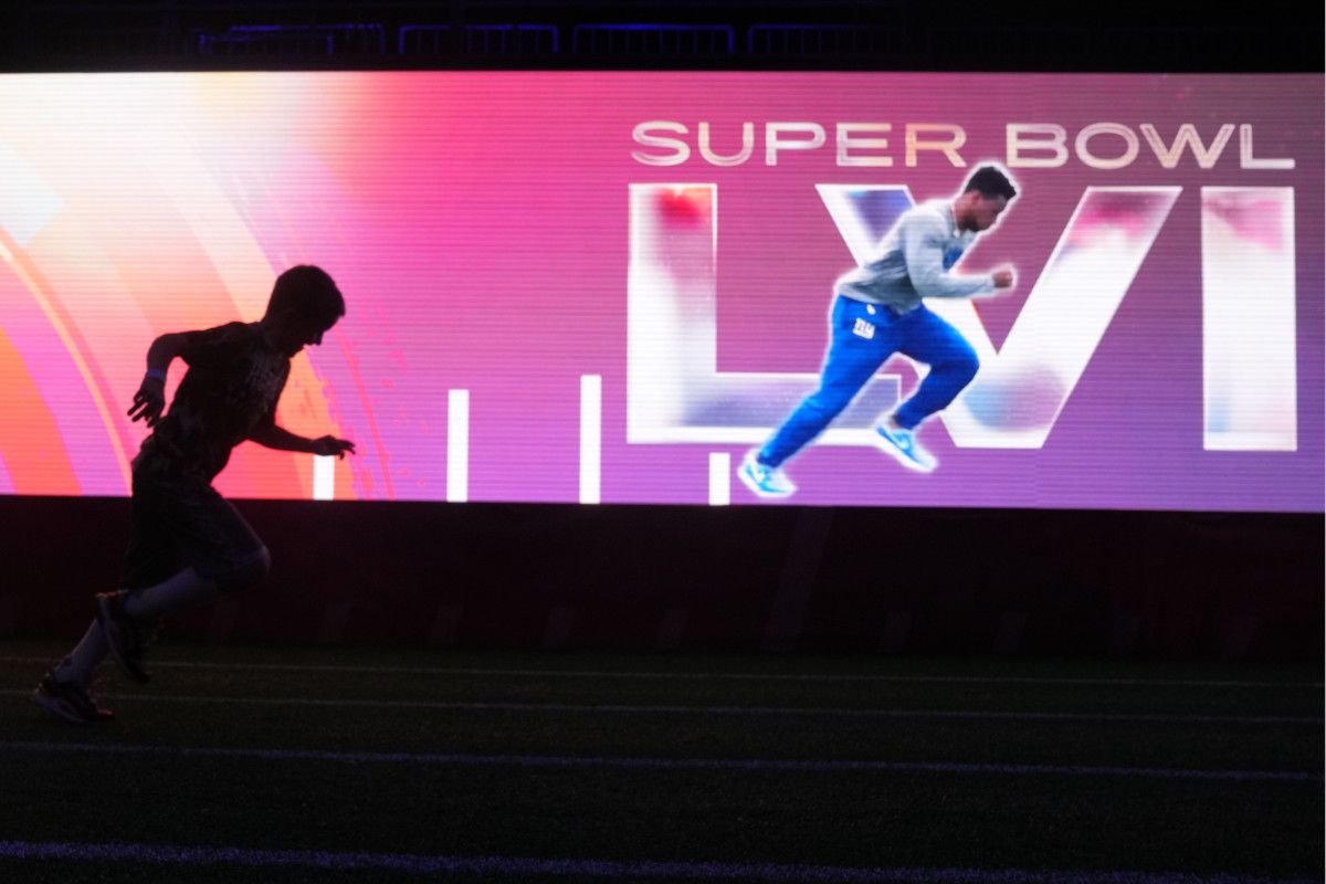 A silhouette of a participant in the 40-yard dash exhibit at the Super Bowl LVI Experience at the Los Angeles Convention Center.