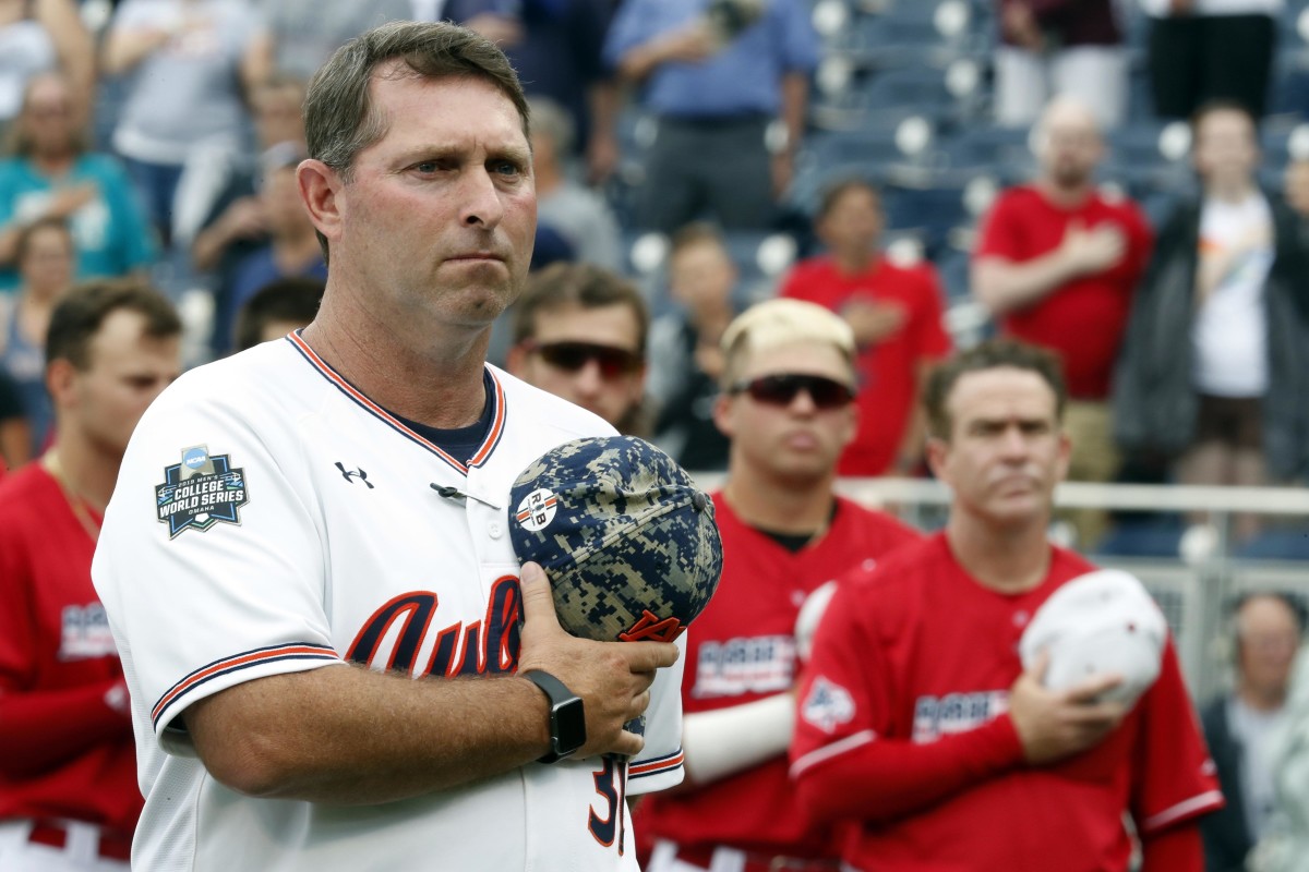Jun 18, 2019; Omaha, NE, USA; Auburn Tigers head coach Butch Thompson observes the national anthem prior to the game against the Louisville Cardinals in the 2019 College World Series at TD Ameritrade Park. Mandatory Credit: Bruce Thorson-USA TODAY Sports
