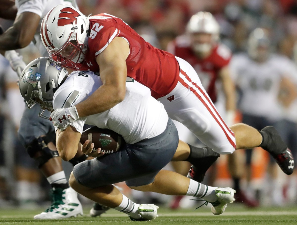 Wisconsin Badgers defensive end Matt Henningsen (92) sacks Eastern Michigan Eagles quarterback Ben Bryant (8) during their football game on Saturday, September 11, 2021 in Madison, Wis.