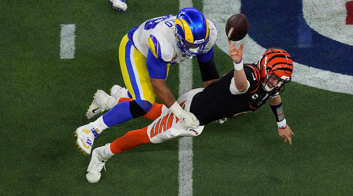 Los Angeles Rams defensive end Aaron Donald (99) forces Cincinnati Bengals quarterback Joe Burrow (9) to throw an incomplete pass during the second half of the NFL Super Bowl 56.
