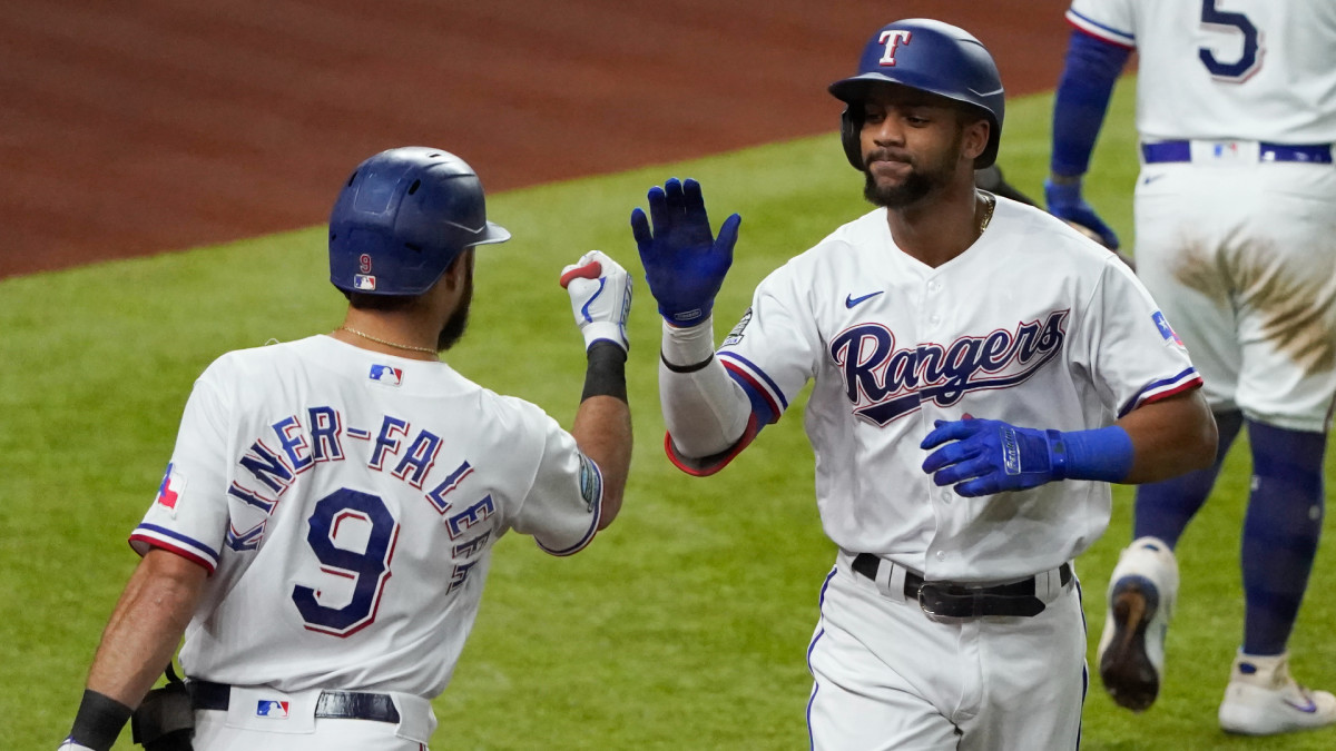 Sep 26, 2020; Arlington, Texas, USA; Texas Rangers center fielder Leody Taveras (65) is congratulated by third baseman Isiah Kiner-Falefa (9)after hitting a solo home run against the Houston Astros during the seventh inning at Globe Life Field. Mandatory Credit: Jim Cowsert-USA TODAY Sports