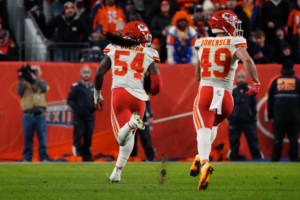 Jan 8, 2022; Denver, Colorado, USA; Kansas City Chiefs outside linebacker Nick Bolton (54) returns a fumble for a touchdown as safety Daniel Sorensen (49) looks back in the fourth quarter against the Denver Broncos at Empower Field at Mile High. Mandatory Credit: Ron Chenoy-USA TODAY Sports