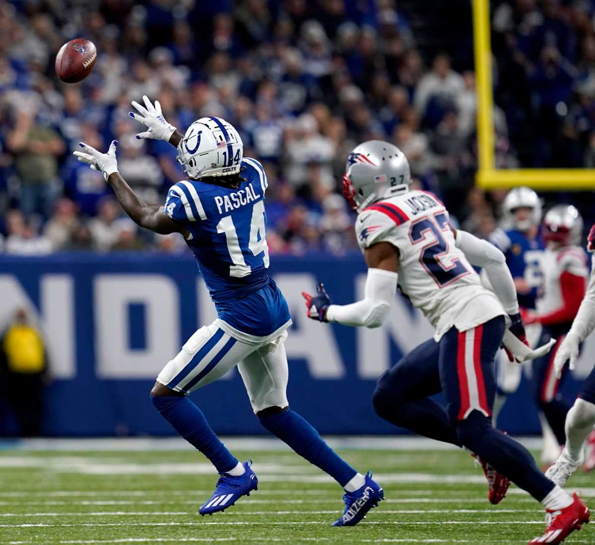 Indianapolis Colts wide receiver Zach Pascal (14) completes a catch ahead of New England Patriots cornerback J.C. Jackson (27) on Saturday, Dec. 18, 2021, during a game against the New England Patriots at Lucas Oil Stadium in Indianapolis.