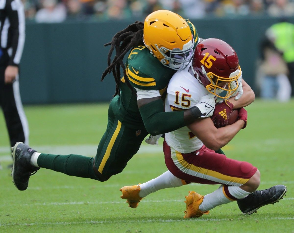 Green Bay Packers linebacker De'Vondre Campbell (59) stops Washington football team wide receiver Dax Milne (15) short of a first down during the third quarter of their game Sunday, October 25, 2021 at Lambeau Field in Green Bay, Wis. The Green Bay Packers beat the Washington Football Team 24-10.